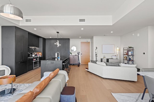 44 E Ave Unit 3402, Austin, TX 78701 - living room featuring light wood-style flooring and recessed lighting