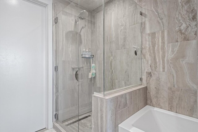 44 E Ave Unit 3402, Austin, TX 78701 - bathroom with a shower stall and a garden tub