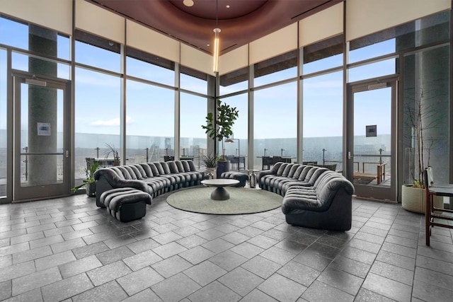 44 E Ave Unit 3402, Austin, TX 78701 - living area featuring floor to ceiling windows, a water view, and a towering ceiling