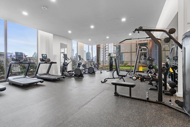 44 E Ave Unit 3402, Austin, TX 78701 - gym with floor to ceiling windows, a view of skyline, and recessed lighting