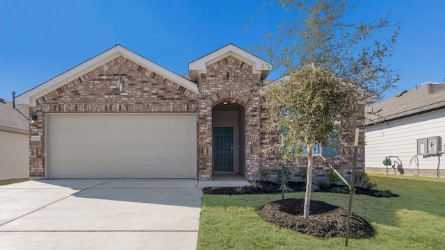 view of front of home with brick siding, an attached garage, a front yard, and concrete driveway