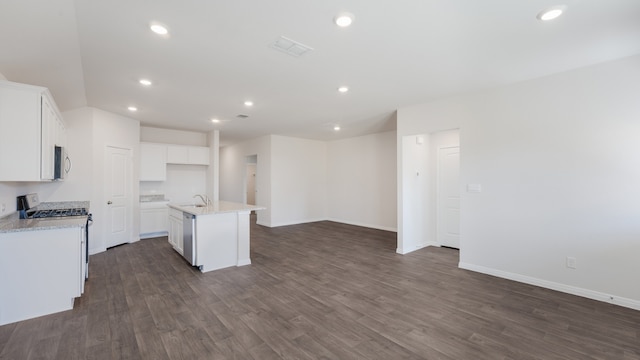 kitchen with a sink, dark wood-style flooring, appliances with stainless steel finishes, and open floor plan