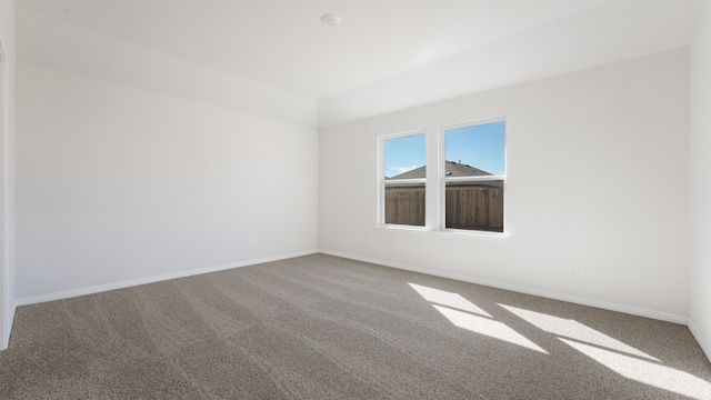 carpeted empty room with baseboards