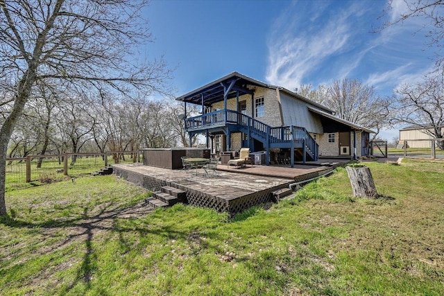 back of property featuring stairway and a deck