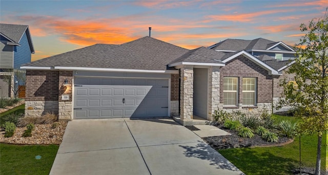 130 Carmello, Kyle, TX 78640 - view of front facade with stone siding, an attached garage, driveway, and a shingled roof