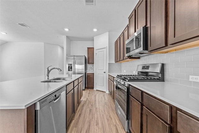 130 Carmello, Kyle, TX 78640 - kitchen with appliances with stainless steel finishes, light wood-style flooring, light countertops, backsplash, and recessed lighting