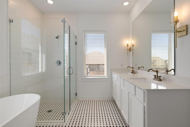 full bath with a soaking tub, a sink, a stall shower, and a healthy amount of sunlight