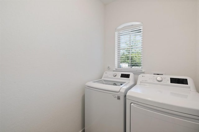 clothes washing area with washing machine and clothes dryer and laundry area