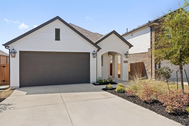 view of front of house featuring brick siding, concrete driveway, a garage, and fence