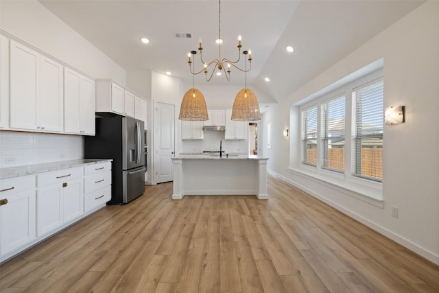 kitchen featuring visible vents, white cabinetry, stainless steel refrigerator with ice dispenser, an inviting chandelier, and backsplash