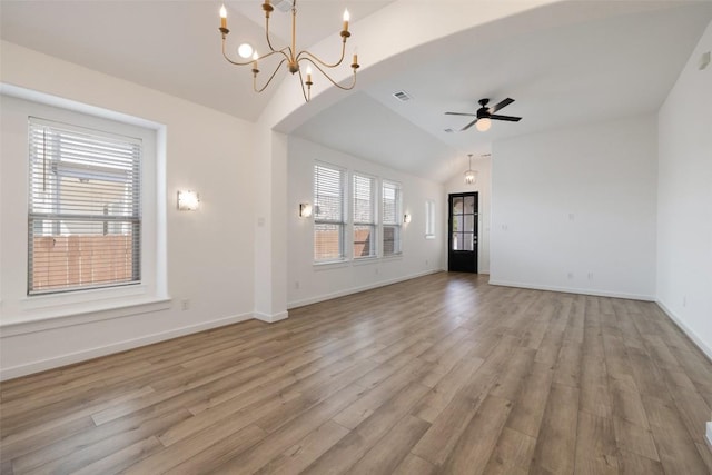 unfurnished living room with vaulted ceiling, light wood-type flooring, baseboards, ceiling fan with notable chandelier, and visible vents