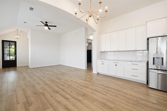kitchen with decorative backsplash, light wood-type flooring, open floor plan, stainless steel fridge with ice dispenser, and ceiling fan with notable chandelier