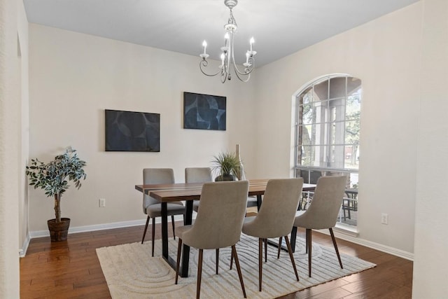 2701 Blackstone Cv, Round Rock, TX 78665 - dining space featuring a chandelier, hardwood / wood-style flooring, and baseboards