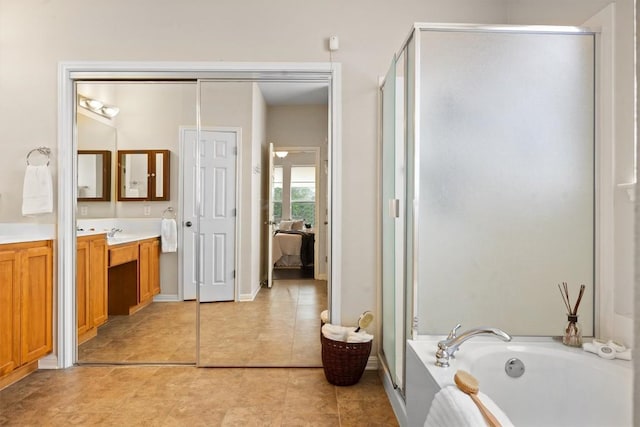 2701 Blackstone Cv, Round Rock, TX 78665 - bathroom featuring vanity, a shower stall, a garden tub, and tile patterned flooring