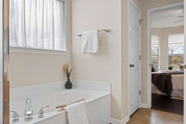 2701 Blackstone Cv, Round Rock, TX 78665 - bathroom featuring ensuite bath, a garden tub, tile patterned floors, and baseboards
