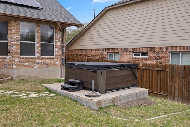 2701 Blackstone Cv, Round Rock, TX 78665 - exterior view of a hot tub, brick siding, and a shingled roof