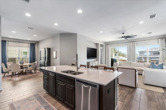 9003 Jodie Ln, Austin, TX 78748 - kitchen with stainless steel dishwasher, a sink, wood finished floors, plenty of natural light, and recessed lighting