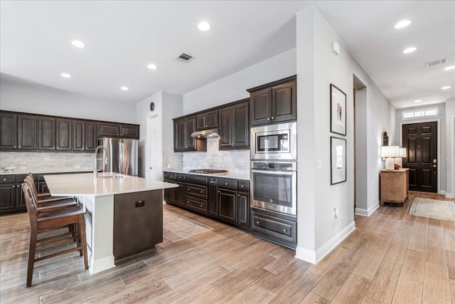 9003 Jodie Ln, Austin, TX 78748 - kitchen with stainless steel appliances, light countertops, under cabinet range hood, tasteful backsplash, and recessed lighting
