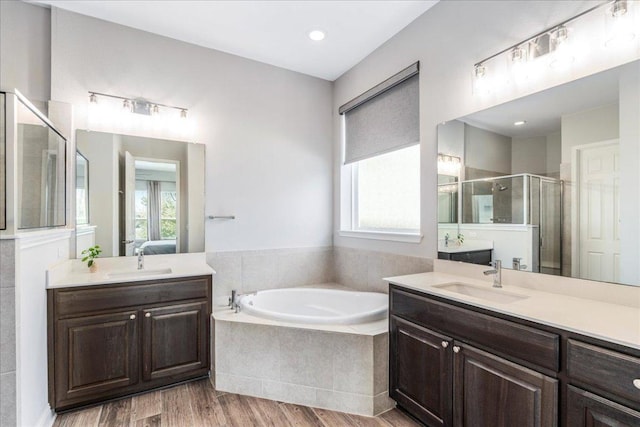 9003 Jodie Ln, Austin, TX 78748 - bathroom featuring healthy amount of natural light, a stall shower, a garden tub, two vanities, and recessed lighting