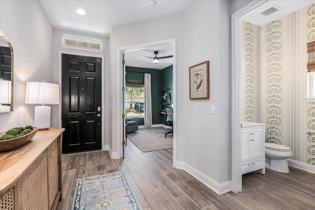 9003 Jodie Ln, Austin, TX 78748 - entrance foyer with wood finished floors, baseboards, a ceiling fan, arched walkways, and recessed lighting