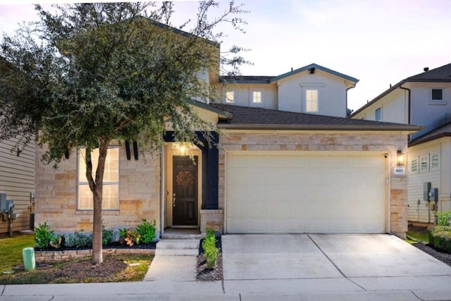 9003 Jodie Ln, Austin, TX 78748 - traditional home featuring concrete driveway, an attached garage, and stone siding
