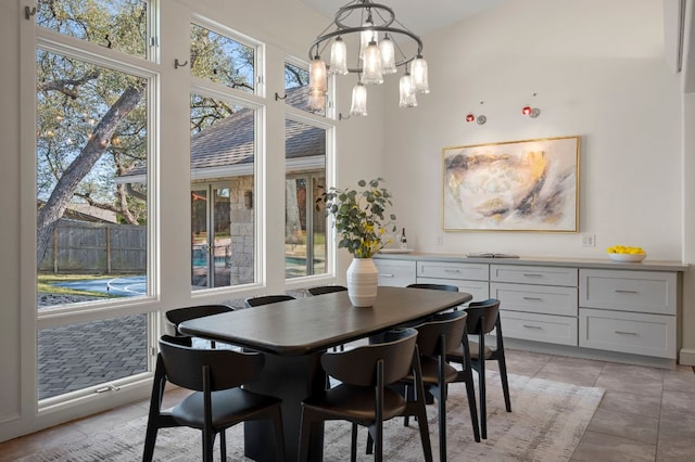 7603 Rustling Cv, Austin, TX 78731 - dining space with a chandelier, a high ceiling, and light tile patterned floors