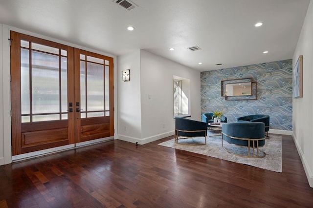 7603 Rustling Cv, Austin, TX 78731 - foyer featuring french doors, wallpapered walls, an accent wall, wood finished floors, and recessed lighting