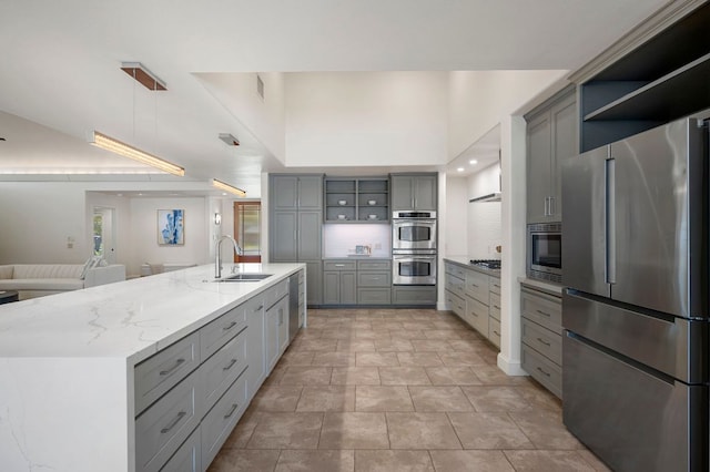 7603 Rustling Cv, Austin, TX 78731 - kitchen featuring appliances with stainless steel finishes, gray cabinets, open shelves, backsplash, and recessed lighting
