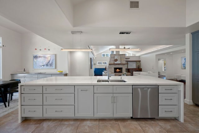 7603 Rustling Cv, Austin, TX 78731 - kitchen with dishwasher, open floor plan, a large fireplace, pendant lighting, and light stone countertops