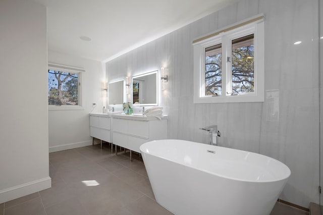 7603 Rustling Cv, Austin, TX 78731 - full bathroom with double vanity, a freestanding tub, and tile patterned flooring