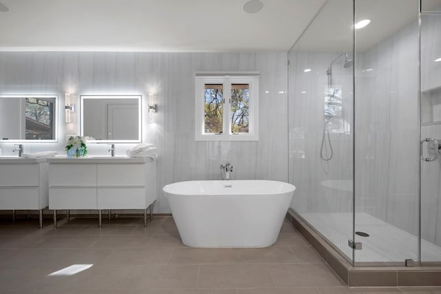 7603 Rustling Cv, Austin, TX 78731 - bathroom featuring a shower stall, double vanity, a freestanding tub, and tile patterned flooring