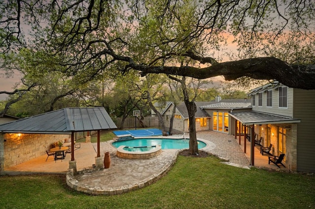 7603 Rustling Cv, Austin, TX 78731 - view of pool featuring a patio, a pool with connected hot tub, and a fenced backyard