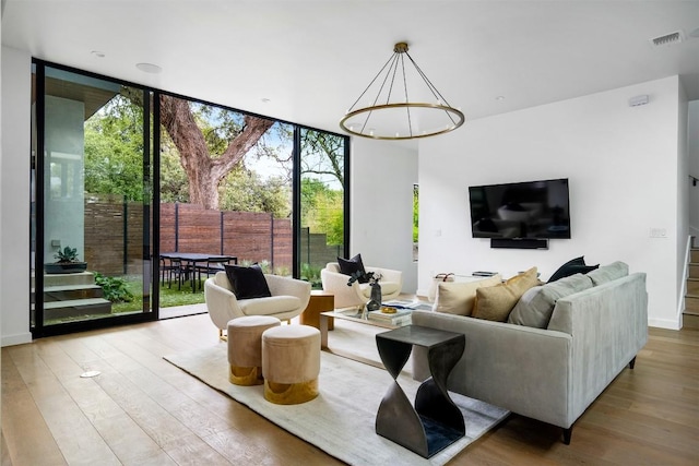 1411 Travis Heights Blvd, Austin, TX 78704 - living area with an inviting chandelier, visible vents, floor to ceiling windows, and wood finished floors