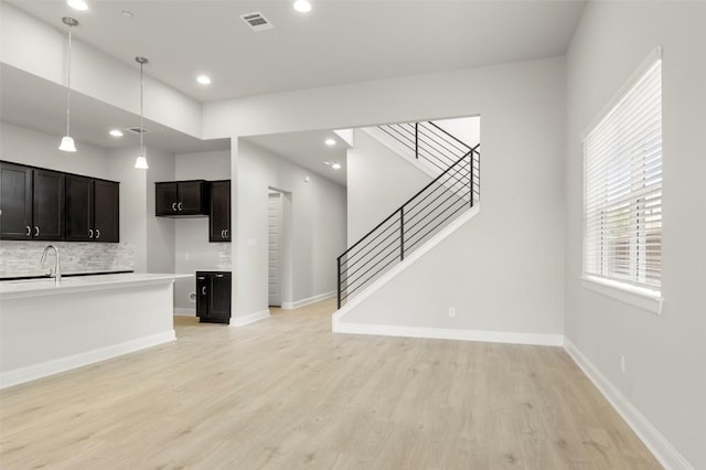 600 C-Bar Ranch Trl Unit 116, Cedar Park, TX 78613 - unfurnished living room with light wood finished floors, recessed lighting, and stairs