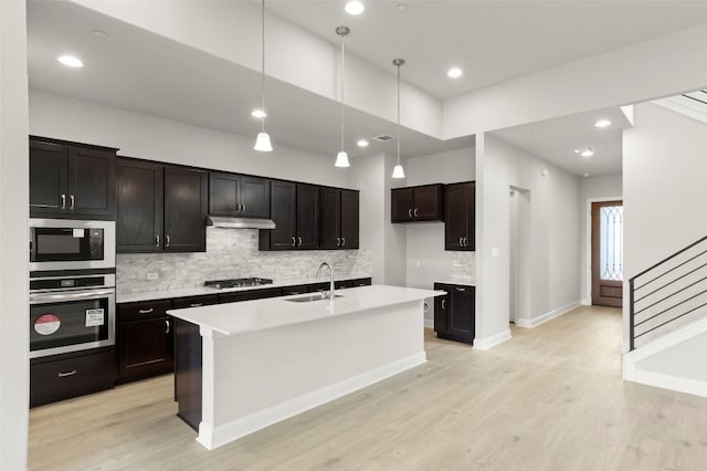 600 C-Bar Ranch Trl Unit 116, Cedar Park, TX 78613 - kitchen featuring appliances with stainless steel finishes, backsplash, light wood-style flooring, light countertops, and recessed lighting