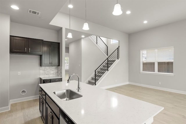 600 C-Bar Ranch Trl Unit 116, Cedar Park, TX 78613 - kitchen with light wood-style floors, hanging light fixtures, decorative backsplash, recessed lighting, and an island with sink