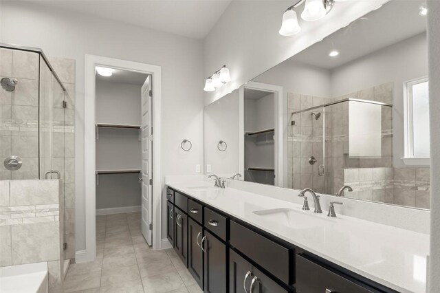 600 C-Bar Ranch Trl Unit 116, Cedar Park, TX 78613 - full bath featuring a walk in closet, a stall shower, double vanity, and tile patterned flooring