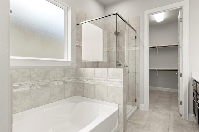 600 C-Bar Ranch Trl Unit 116, Cedar Park, TX 78613 - bathroom with a bath, a stall shower, a spacious closet, and vanity