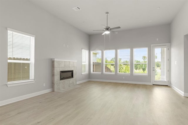 600 C-Bar Ranch Trl Unit 116, Cedar Park, TX 78613 - unfurnished living room with light wood-type flooring, a fireplace, plenty of natural light, and ceiling fan