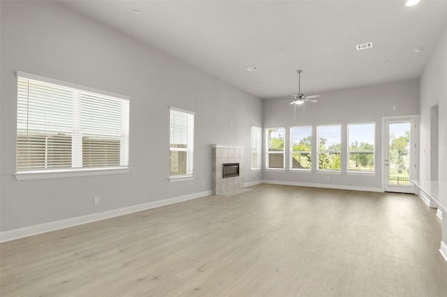 600 C-Bar Ranch Trl Unit 116, Cedar Park, TX 78613 - unfurnished living room featuring ceiling fan, light wood finished floors, and a tiled fireplace