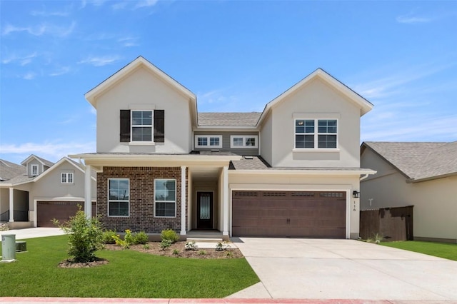 600 C-Bar Ranch Trl Unit 116, Cedar Park, TX 78613 - view of front facade featuring concrete driveway, stucco siding, a front yard, an attached garage, and brick siding