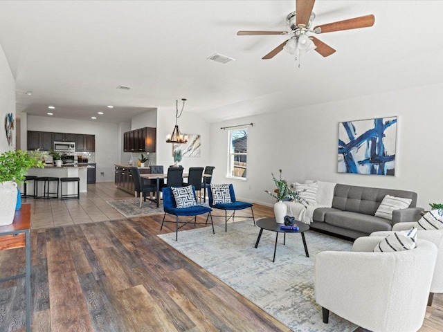 living area with visible vents, baseboards, a ceiling fan, recessed lighting, and wood finished floors