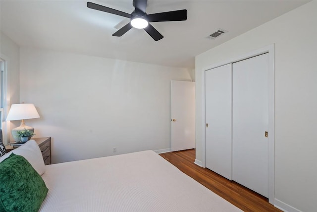 2708 W 49th St W, Austin, TX 78731 - bedroom with wood finished floors, a closet, ceiling fan, and baseboards