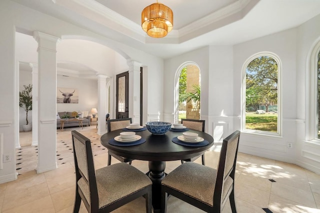 503 Eagle, Lakeway, TX 78734 - dining area with decorative columns, light tile patterned flooring, a tray ceiling, crown molding, and arched walkways