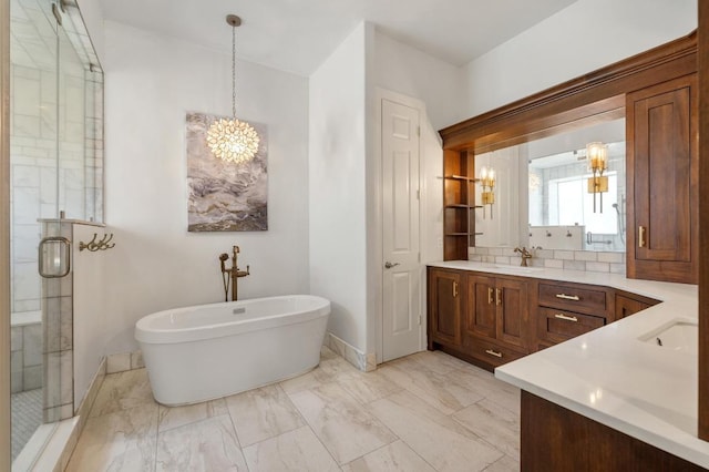 503 Eagle, Lakeway, TX 78734 - bathroom featuring a chandelier, a stall shower, vanity, baseboards, and a freestanding tub
