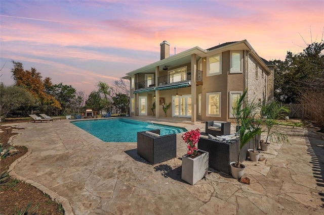 503 Eagle, Lakeway, TX 78734 - pool at dusk with an outdoor hangout area, a patio, and an outdoor pool