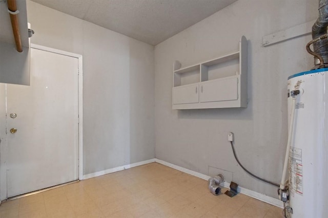 703 S 13th St, Copperas Cove, TX 76522 - laundry area with gas water heater and light flooring