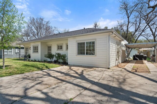 1213 S Church St, Georgetown, TX 78626 - view of front of home with a front yard, a patio, concrete driveway, and a carport