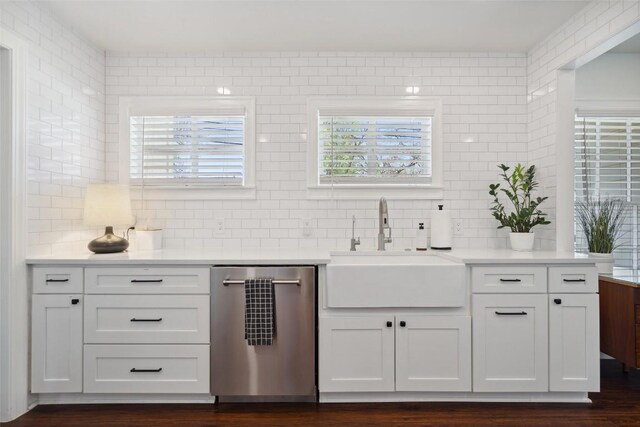 1213 S Church St, Georgetown, TX 78626 - bar featuring stainless steel dishwasher, a sink, tasteful backsplash, and dark wood-style flooring