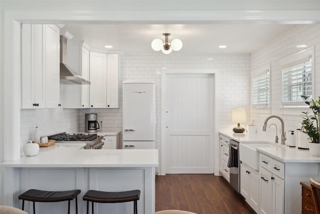 1213 S Church St, Georgetown, TX 78626 - kitchen with a sink, range, freestanding refrigerator, tasteful backsplash, and a peninsula